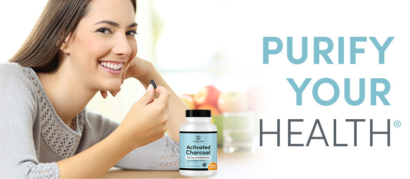 Activated Charcoal Capsules in womans hand 